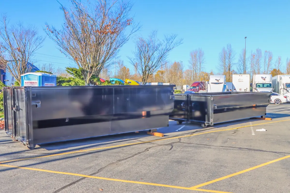 Professional dumpster rental service with roll-off container on residential driveway in Breckenridge